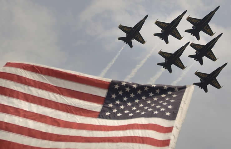 blue angels flying in formation over the american flag