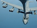 b-52 being refueled by a kc-10 in flight