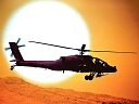 apache helicopter flying at sundown