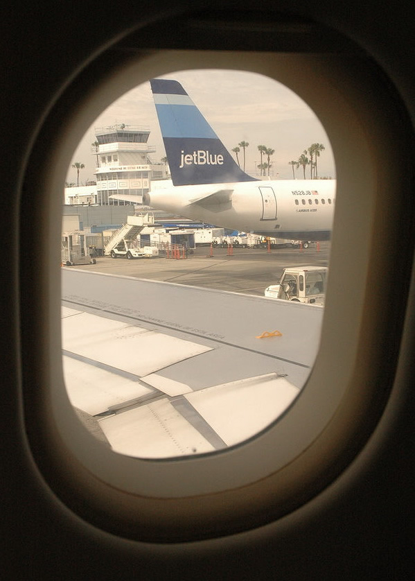 looking out the window on a jetblue airbus a320 airplane